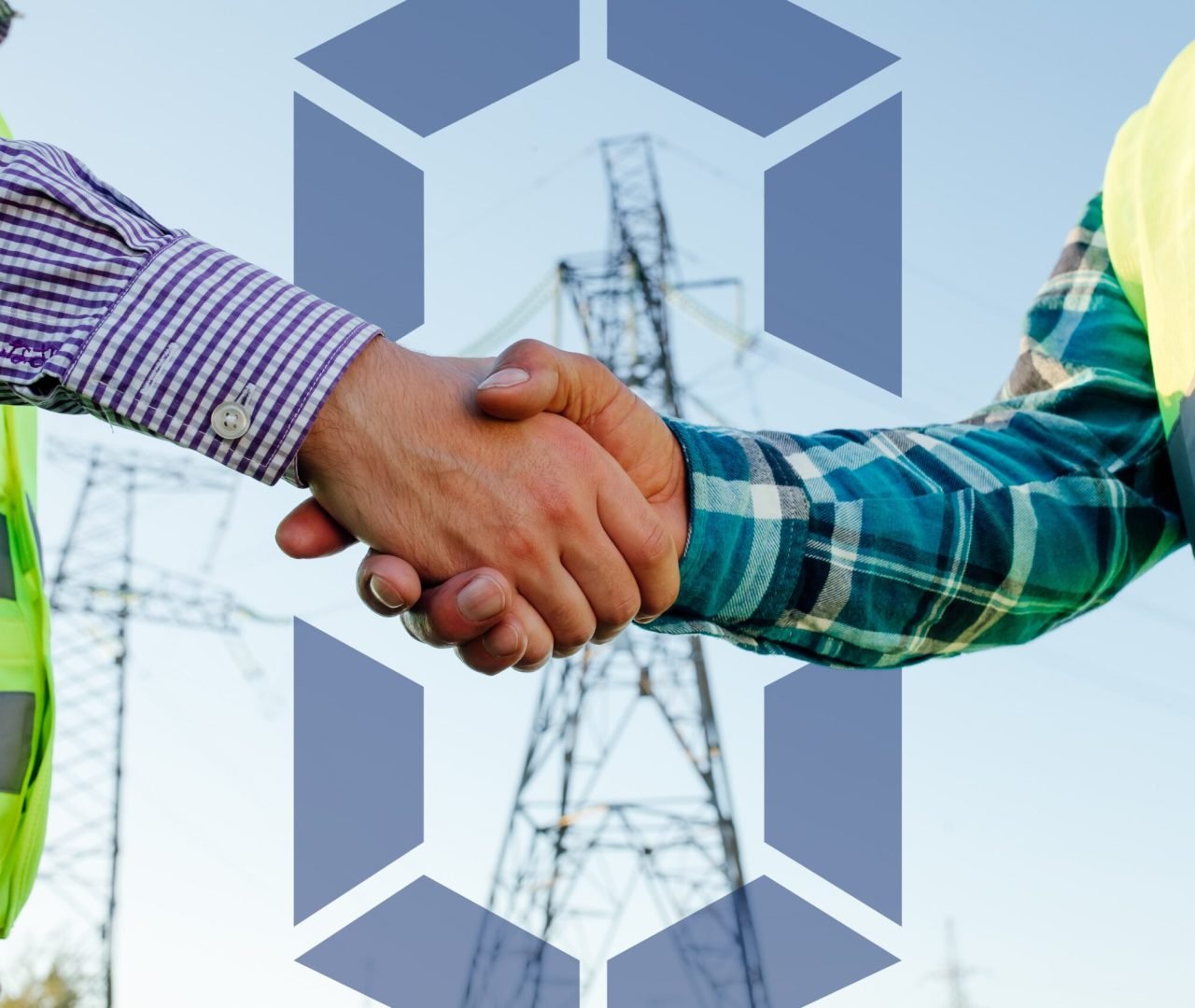 engineers-shaking-hands-against-high-voltage-tower-2024-10-18-09-04-06-utc-min